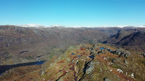Revealing-Nesheim-and-Bergo-in-Eksingedalen-valley-Norway-from-nearby-mountain-top---Sunny-autumn-day-forward-moving-aerial-looking-down-at-Bergo-freshwater-lake
