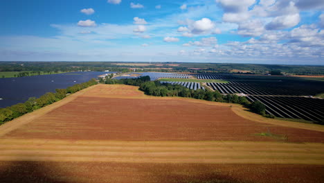 Panoramic-View-Of-Solar-Panels-In-Rural-Plains-With-Beautiful-Clouds-In-Blue-Sky