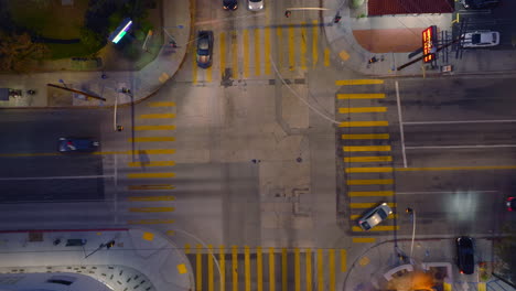 Aerial-Drone-Shot-of-Cars-Moving-Through-Busy-Intersection-at-Dusk,-Twilight-Traffic