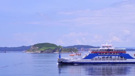 Ferry-crossing-the-Screen-with-mountains-on-the-Horizon-in-Costa-Rican-Landscape-on-Sunny-Day-with-cloudy-Sky