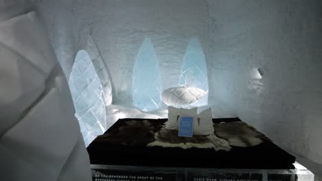 Ice-room-with-bed-and-ice-sculptures-in-Ice-Hotel-in-Scandinavia,-Sweden
