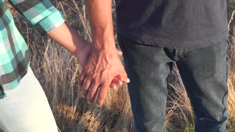 Woman-holding-hands-with-a-man,-slow-motion,-outdoors-detail-shot