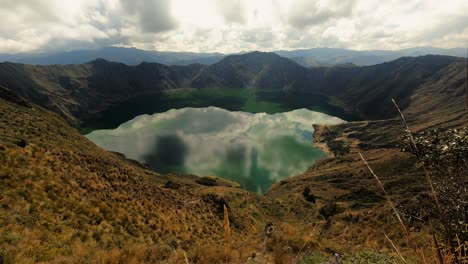 Quilotoa-Lagoon-Water-Filled-Crater-Lake-Ecuador-Andes-Volcano-Aerial-Time-Lapse-of-Crystalline-Water,-Andean-Cordillera-and-Clouds-Movement