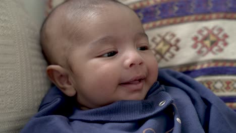 Entzückender-2-Monate-Alter-Indischer-Junge,-Der-Lächelt,-Lacht-Und-Die-Zunge-Herausstreckt,-Während-Er-Auf-Dem-Kissen-Ruht