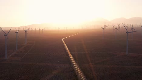 Wind-turbines-at-sunset-in-the-Mojave-desert,-aerial-static-view