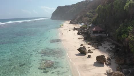Pantai-Melasti-beach-Bali,-Indonesia-flyover-beautiful-sandy-tropical-white-sand-beach