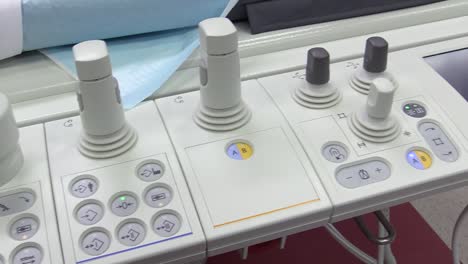 view-of-sticks-and-buttons-on-the-control-panel-of-hospital-scanning-system