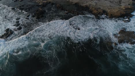 Slow-motion-footage-of-waves-crashing-on-rocks-at-the-ocean