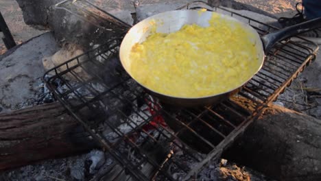 Making-scrumbled-eggs-on-campfire-at-campsite-in-Central-Kalahari-Game-Reserve