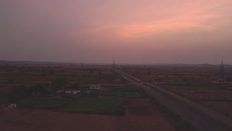 Aerial-Drone-shot-of-a-Highway-at-the-time-of-Sunset