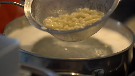 Making-Slovakia-national-food-at-home,-delicious-halusky-scooped-out-of-pot