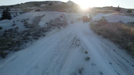 Land-Rover-cruising-through-desert-during-sunset