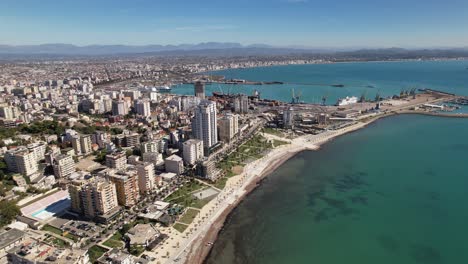 Aerial-view-of-Durres-in-Albania,-coastal-city-with-buildings,-beach-and-port-surrounded-by-Adriatic-sea