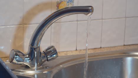 Household-water-tap-running-in-slow-motion