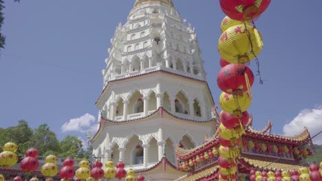 Pagoda-in-Kek-Lok-Si-temple-with-Chinese-lanterns-in-Air-Itam,-tilt-up