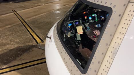 External-view-of-a-modern-medium-size-jet-cockpit-powered,-night-light