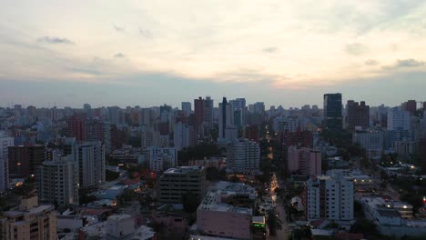 Rising-aerial-view-of-skyline-in-Barranquilla,-Colombia-right-after-sunset