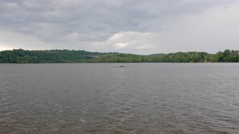 A-single-rower-moves-across-this-midwestern-urban-lake-with-storm-clouds-in-the-background