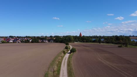 Gorgeous-aerial-view-flight-raise-up-drone-at-Farmer-acker-Path-field-on-island-poel-germany-autumn-2022