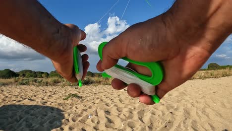 Uncommon-point-of-view-of-hands-flying-green-kite-by-holding-green-handles