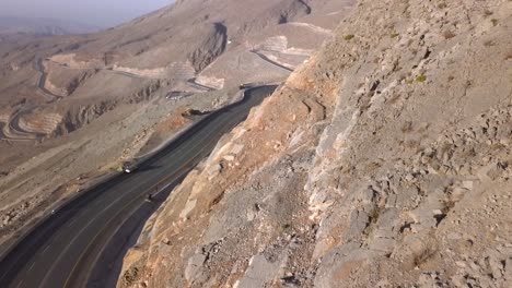 The-road-by-the-beautiful-mountainside-of-Jebel-Jais-in-Ras-Al-Khaimah,-UAE---Aerial-shot