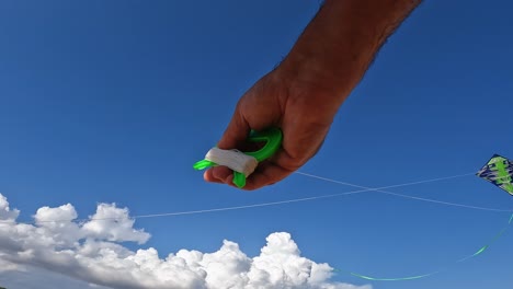 Incredible-point-of-view-of-adult-hands-flying-green-kite-by-holding-green-string-reels