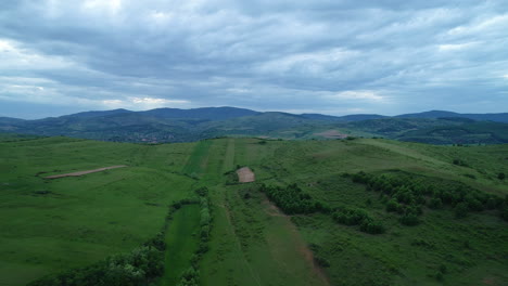 Aerial-view-above-a-large-field-near-an-old-village-from-Europe