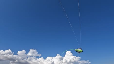 Uncommon-perspective-of-hands-flying-green-kite-by-holding-green-handles