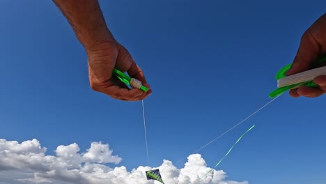 Amazing-point-of-view-of-adult-hands-flying-green-kite-by-holding-green-string-reels