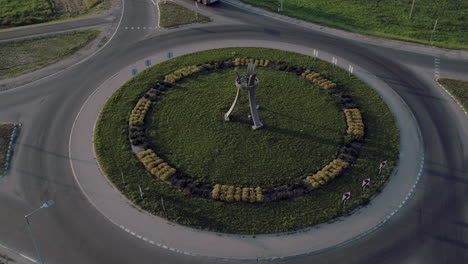 Drone-shot-above-a-roundabout-with-a-truck-and-a-car