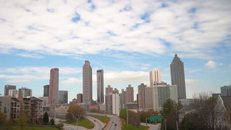 Tilt-shot-starting-on-a-gorgeous,-blue-sky,-then-revealing-Atlanta's-iconic-skyline