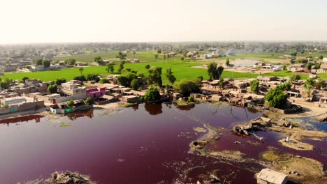 Aerial-View-Of-Dark-Red-Stale-Putrid-Floodwaters-In-Daharki