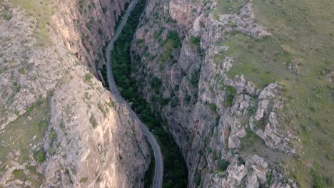 Road-passing-through-canyon-drone-reveal-shot