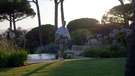 Slowmotion-shot-of-a-well-dressed-man-walking-upstairs-towards-his-home-in-St-Tropez