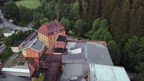 Aerial-view-of-a-demolished-roof-of-a-socialist-lost-place-factory-in-eastern-Germany-filmed-with-drone-viewing-down