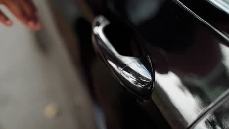 Man's-Hand-Close-up-Opening-the-Car-Door-in-Slow-Motion
