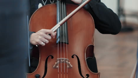 A-man-plays-the-cello-with-his-fingers-in-a-concert-hall