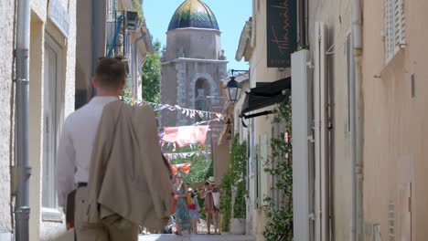 Slowmotion-tilting-shot-of-a-well-dressed-man-walking-down-the-streets-of-Montpellier