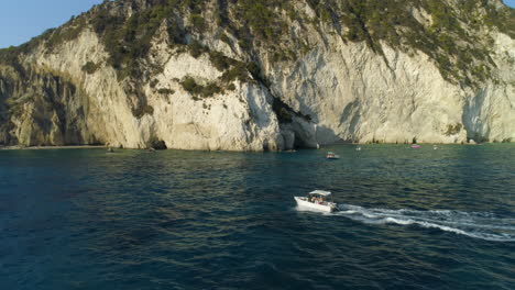 Zokynthos-Greek-island-coastal-sightseeing-boat-tour-aerial-view-following-ocean-voyage