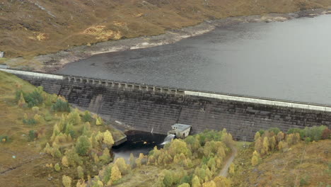 An-aerial-view-of-Cluanie-Dam-on-Loch-Cluanie-in-the-Northwest-Highlands-of-Scotland-at-the-SE-end-of-Glen-Shiel-on-an-overcast-day