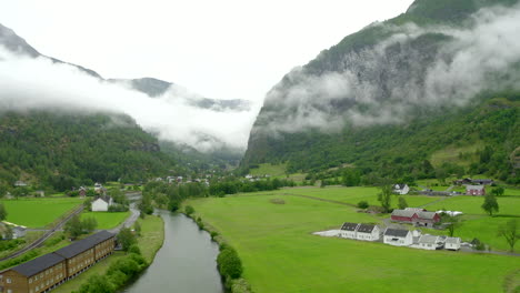 Establishing-shoot-of-drone-flying-in-Norway---Aurlandsfjord--Flam-slowly-gaining-altitude-and-flying-towards-a-valley