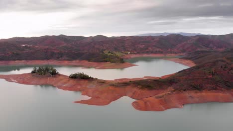 Cloudy-sky-and-low-water-levels-on-a-reservoir-due-to-extreme-drought