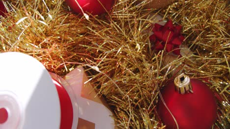 Close-up-shot-of-red-and-gold-Christmas-ornaments-and-fairy-lights