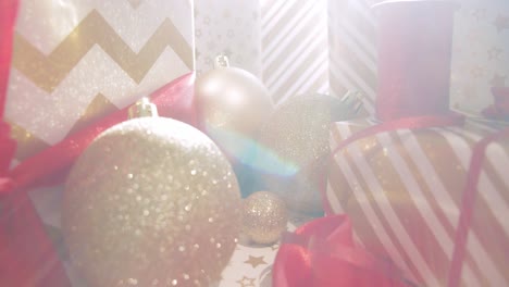 Christmas-decoration-toys-and-wrapped-gift-with-bright-sunlight,-dolly-backward-shot
