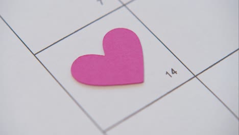 Person-Places-Paper-Heart-on-Calendar-14th-February-Valentine's-Day