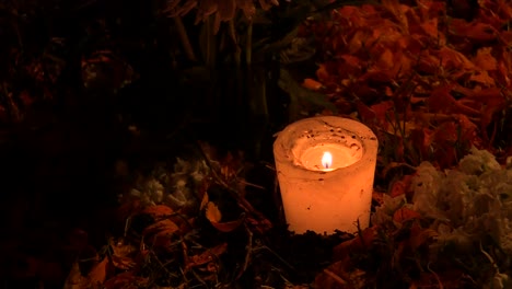 close-up-of-candles-with-a-grave-in-the-mexican-cemetery-of-Mixquic-during-celebration-of-the-day-of-the-dead