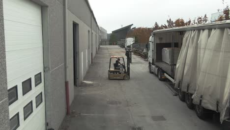Forklift-loading-and-unloading-a-truck-in-an-industrial-zone