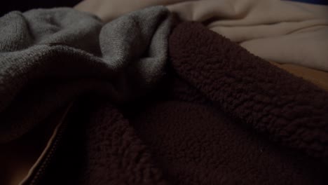 Dark-colored-blankets,-zoom,-slow-motion,-medium-shot