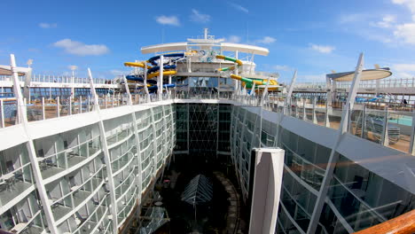 Water-slides-and-swimming-pool-on-top-of-luxury-cruise-ship-cinematic-view|-luxury-cruise-ship-upper-deck-with-beautiful-water-park-and-pools-,-cruising,-travel