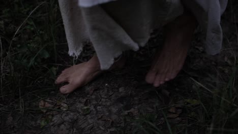 Closeup-of-robed-mans-feet-or-Jesus-walking-through-forest-trees